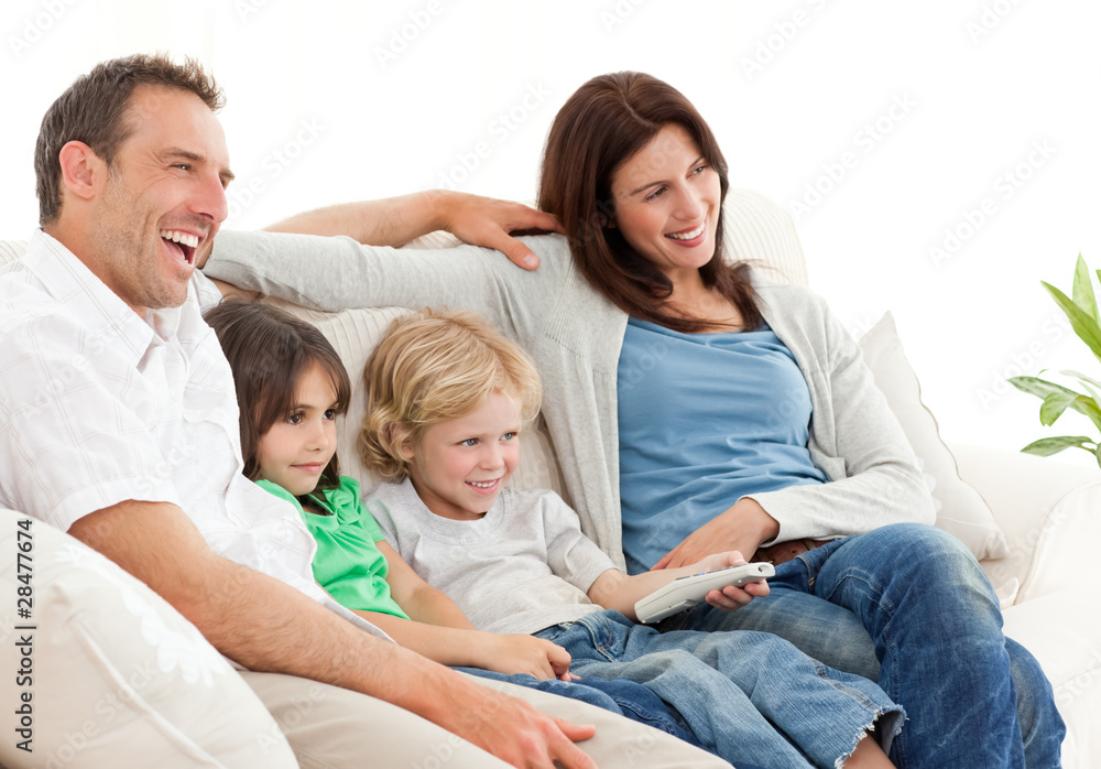 Happy family watching television together Happy family watching television together