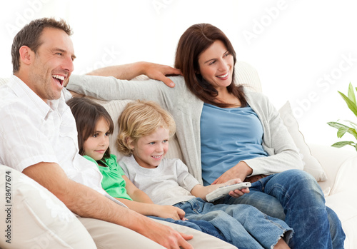 Happy family watching television together