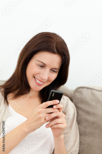 Pretty woman sending a sms with her mobile phone