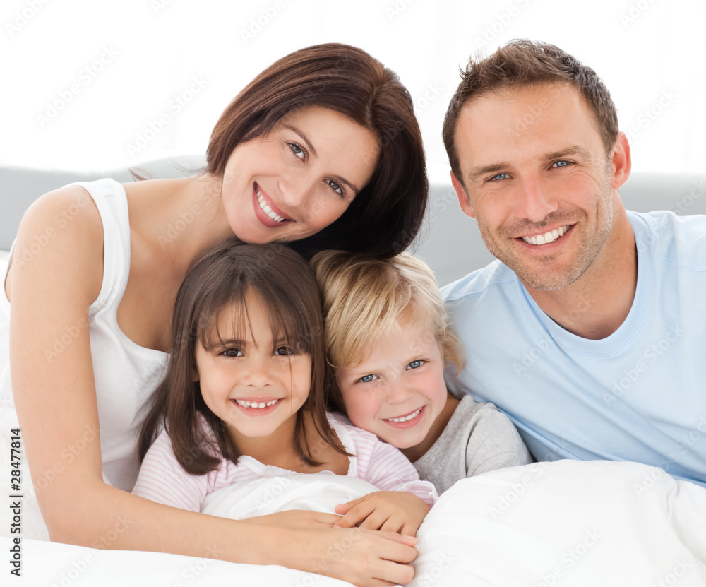 Lovely family sitting together on the bed