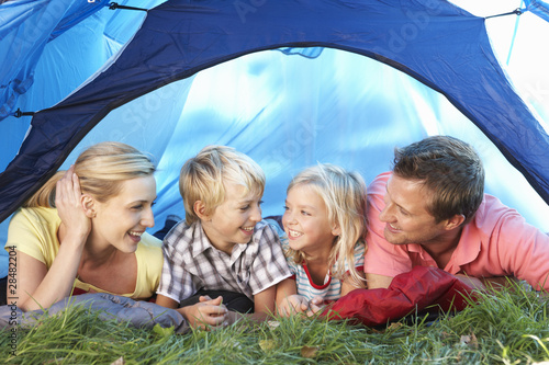 Young family poses in tent © Monkey Business