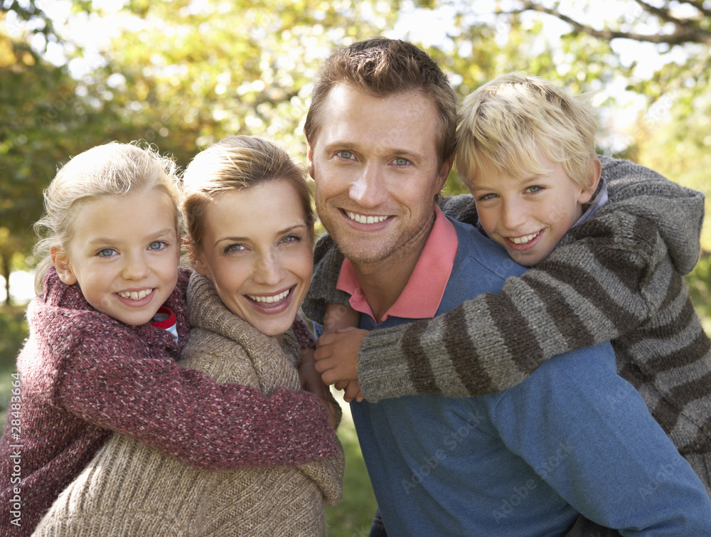 Fototapeta premium Young family pose in park