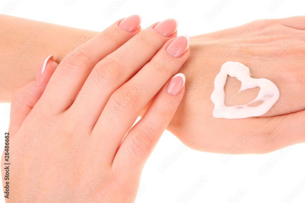 Two woman hands spreading the cream in the form oh heart isolate Two woman hands spreading the cream in the form oh heart isolate