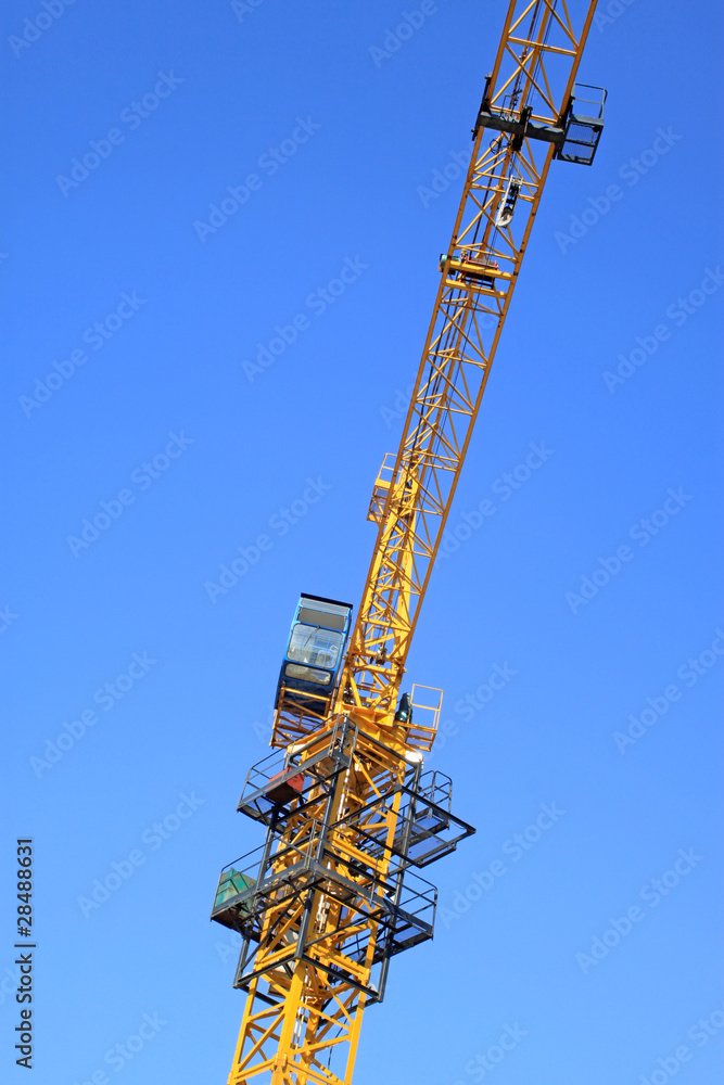 Naklejka premium tower crane under the blue sky