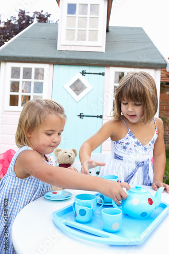 Two young girls play outdoors