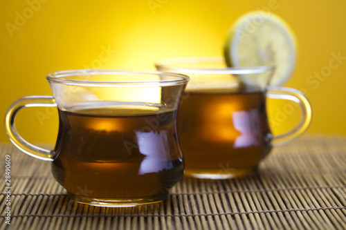 Glass cup of tea with lemon