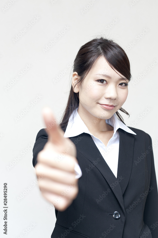 a portrait of young business woman showing thumb up a portrait of young business woman showing thumb up