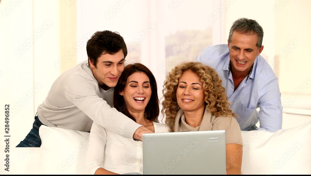 Group of friends at home with laptop computer Group of friends at home with laptop computer