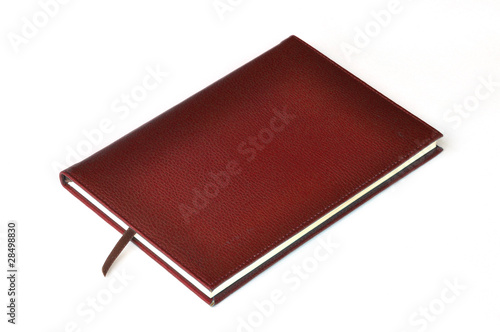 Dark red leather notebook on white background