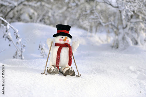 snowman skiing in winter landscape photo