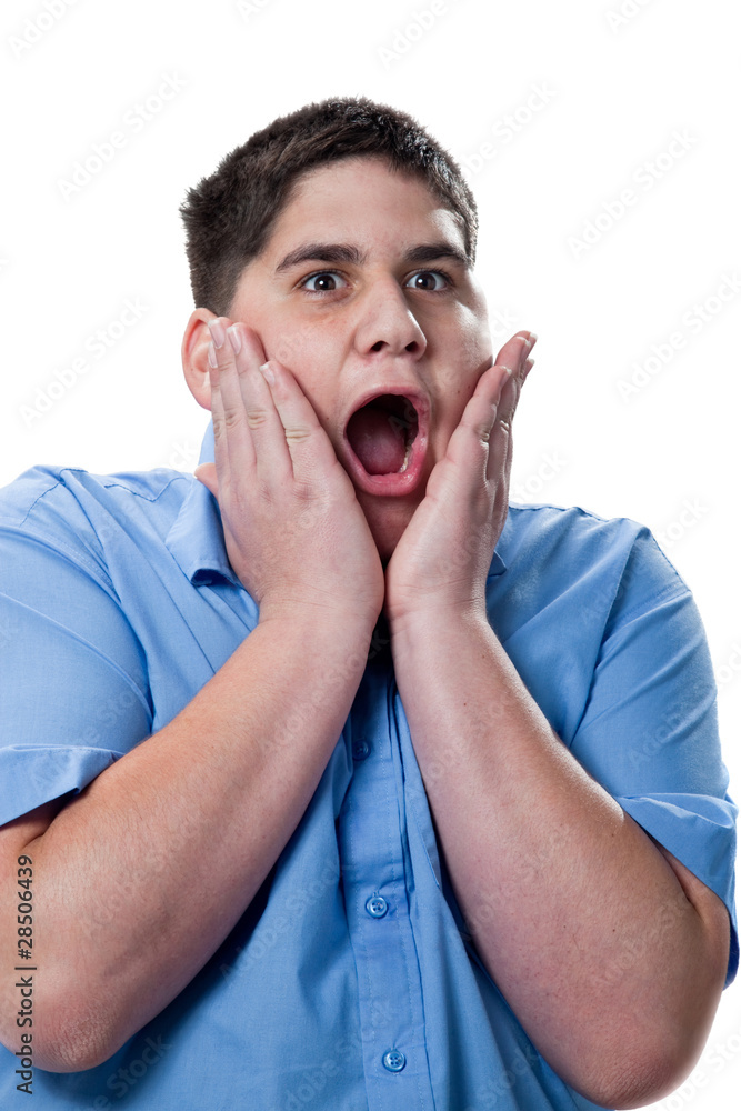 surprised looking boy against a white background surprised looking boy against a white background