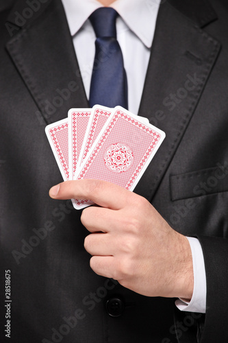 Close up of a man holding cards