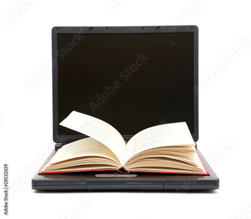 The Open Book Laying On The Laptop
