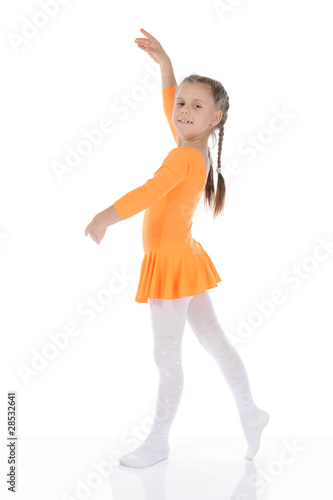 beautiful ballerina dancing in an orange dress.