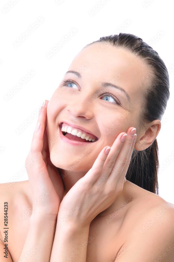 beautiful happy woman is looking sideways and touching her face