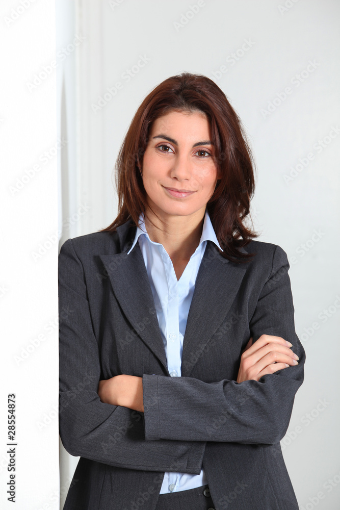 Businesswoman standing against white wall Businesswoman standing against white wall