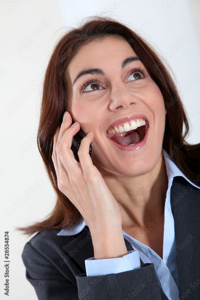 Businesswoman on the phone with surprised look Businesswoman on the phone with surprised look