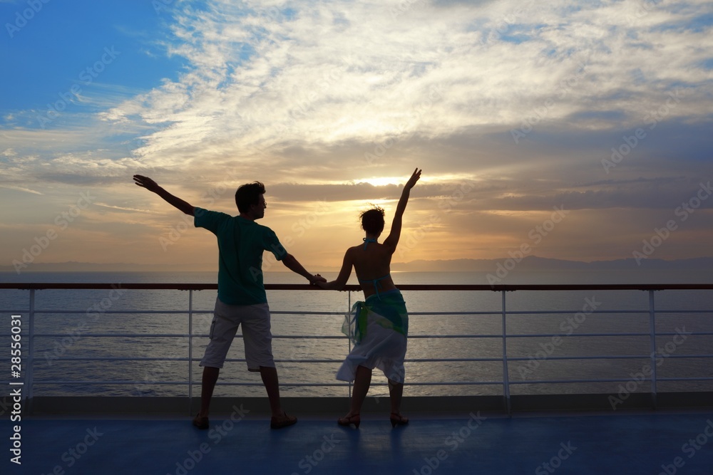 Fototapeta premium man and woman standing on deck of cruise ship and looking away