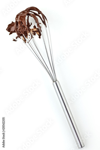 Metal whisk with chocolate isolated on white