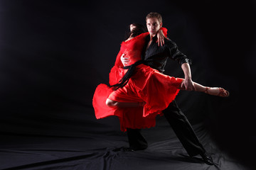 Acrylglasbilder Rot, Schwarz, Weiß dancers in action against black background  © konstantant