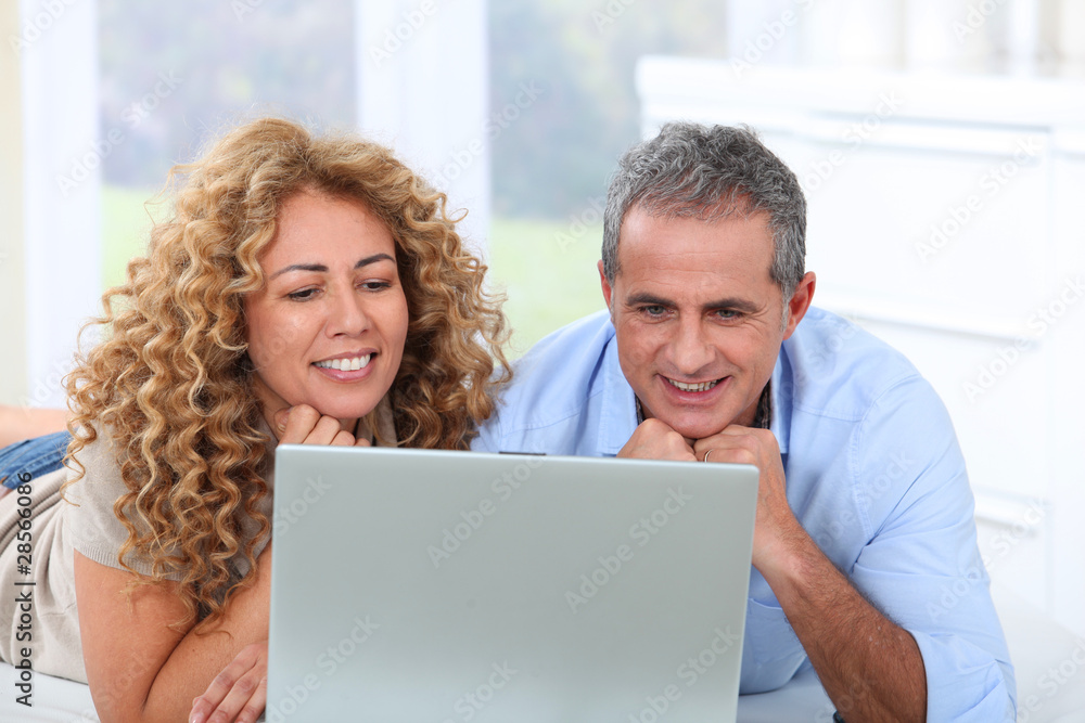 Couple surfing on internet at home Couple surfing on internet at home