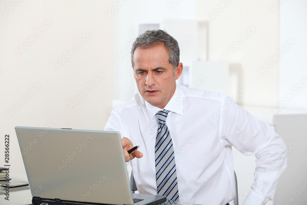 Portrait of smiling businessman in front of computer Portrait of smiling businessman in front of computer