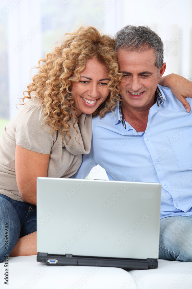 Couple surfing on internet at home Couple surfing on internet at home