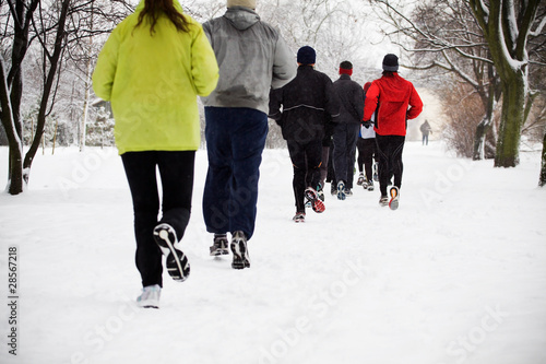 People running in winter park, motion blur
