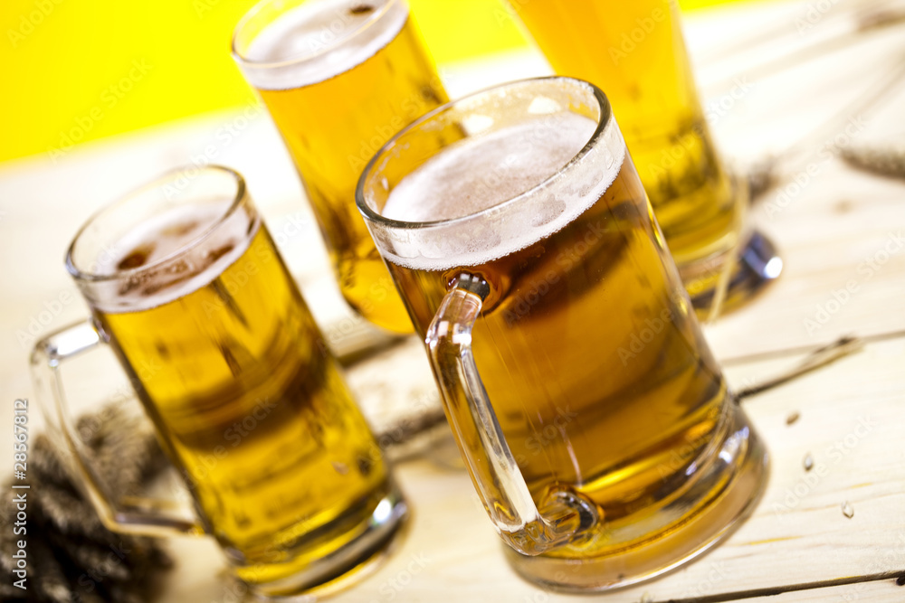 Beer glass with yellow background Beer glass with yellow background