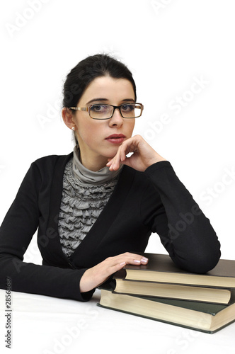 Young beautiful woman in glasses leaning on the books