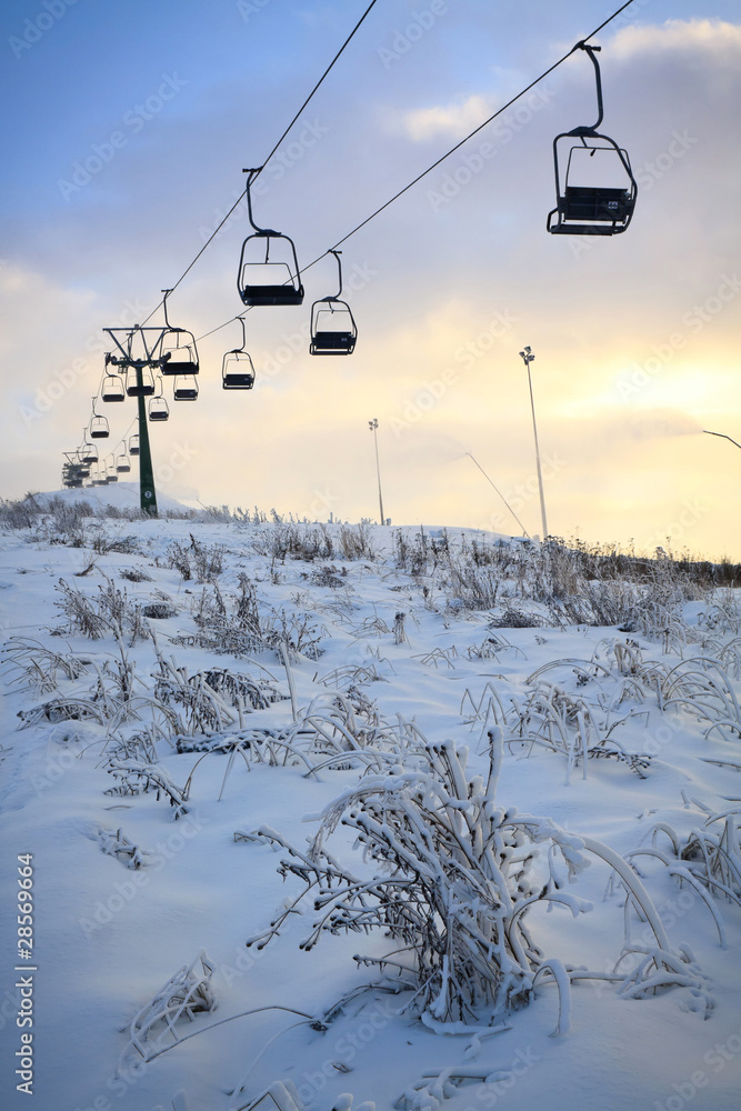 Ski lift line and working snowguns