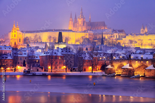 Freezy foggy night snowy Prague with gothic Castle
