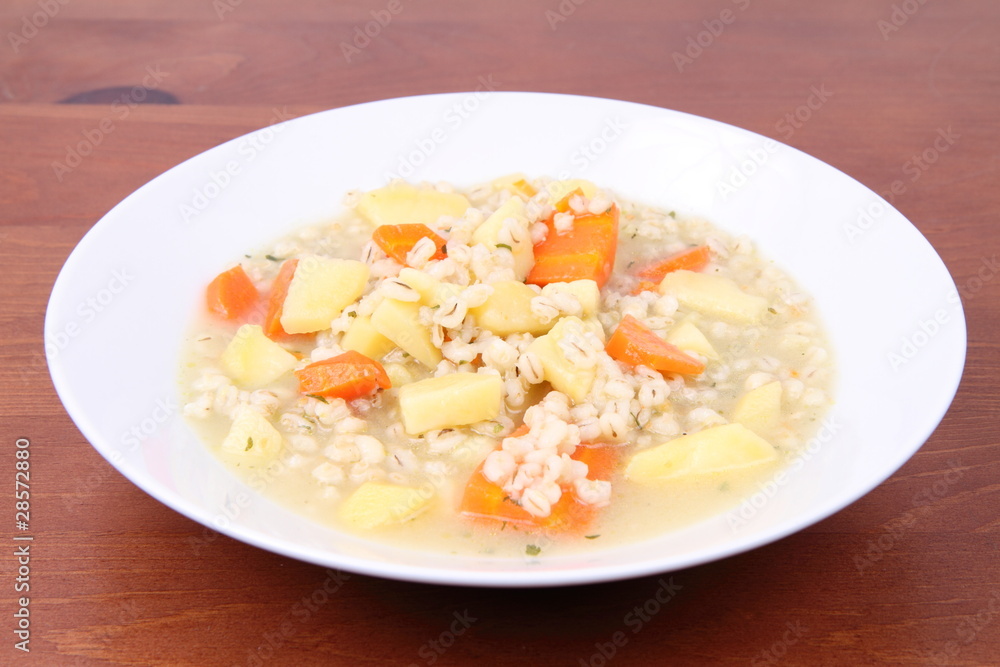 Barley soup on a wooden background