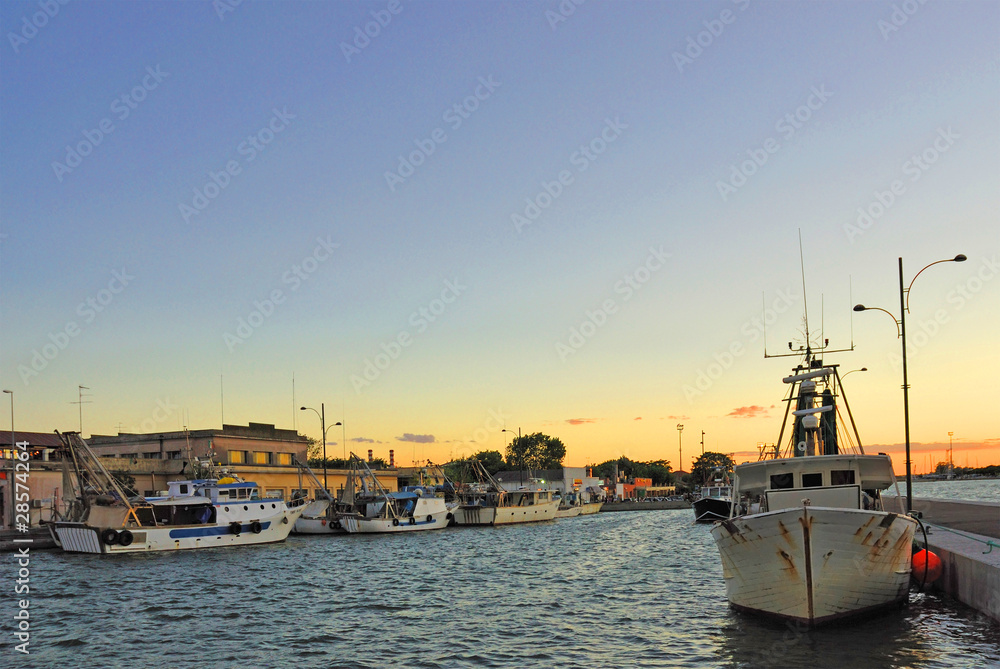 Italy Ravenna marina boats in the fishing harbor at sunset