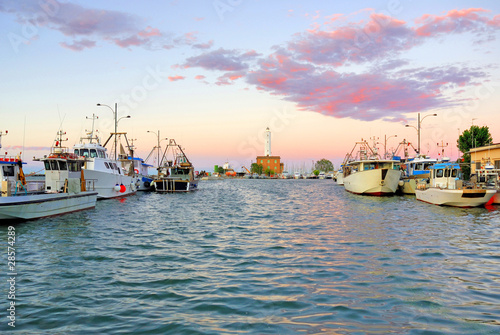 Italy Ravenna marina boats in the fishing harbor at sunset