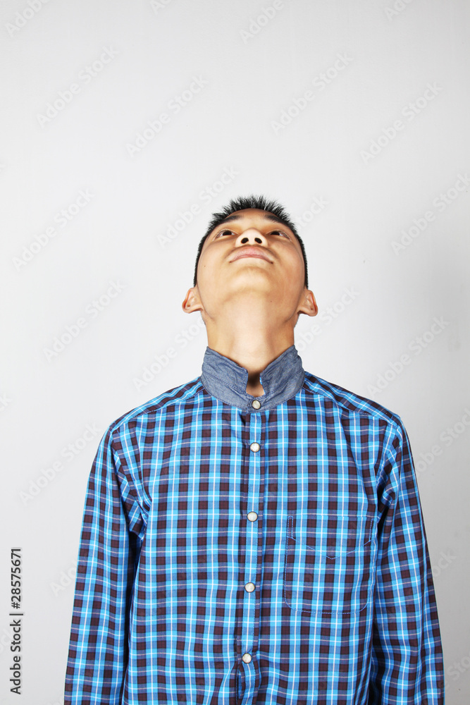 Look up , A boy in blue shirt looking up Look up , A boy in blue shirt looking up