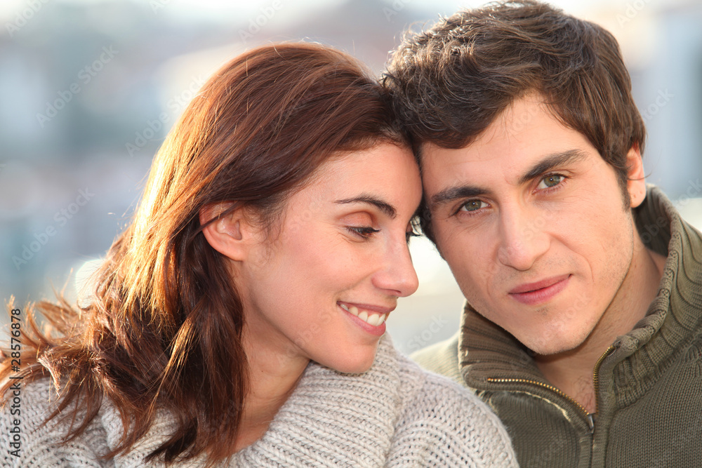Portrait of young smiling couple in town Portrait of young smiling couple in town
