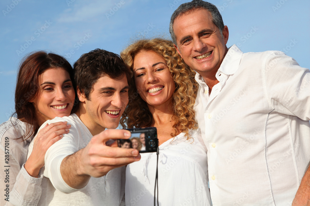 Fototapeta premium Group of friends taking picture of themselves at the beach