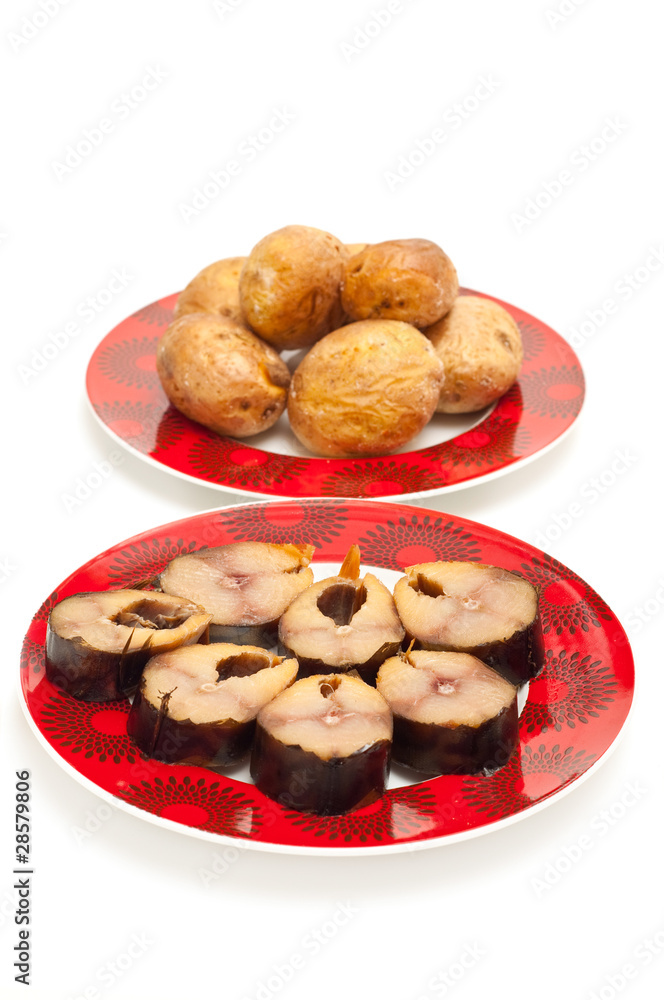 baked potatoes and fish on a plate isolated on white baked potatoes and fish on a plate isolated on white