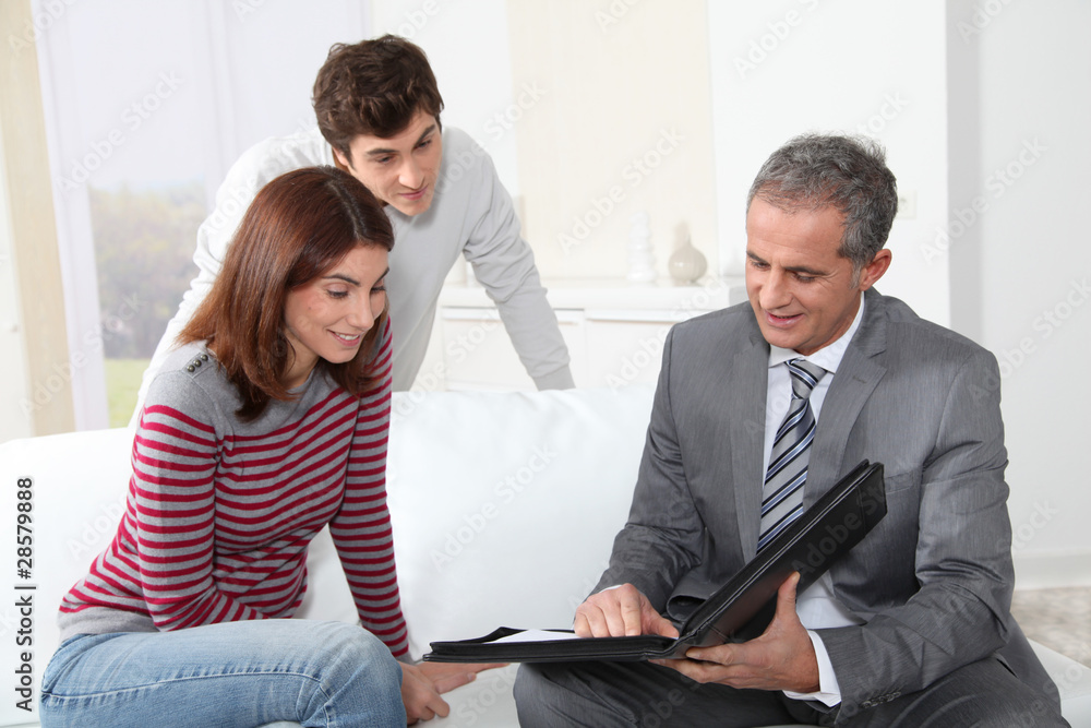Young couple sigining renting contract with real estate agent Young couple sigining renting contract with real estate agent
