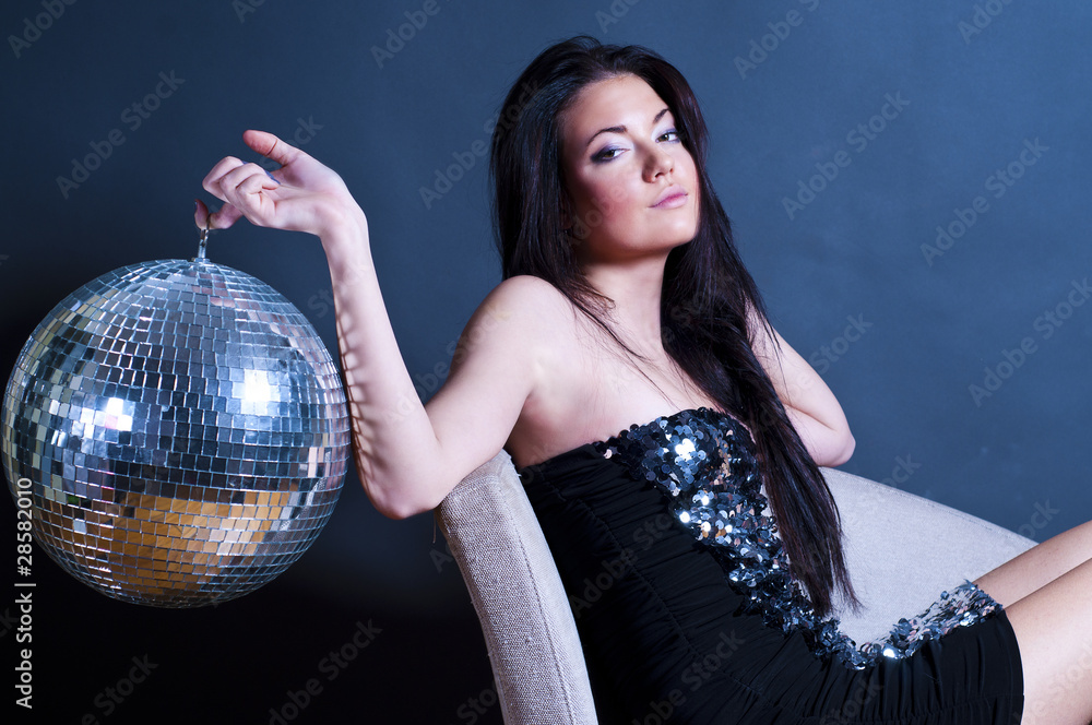 Naklejka premium glamourous young girl with disco ball