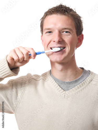 young smiling man brushing teeth with toothbrush isolated