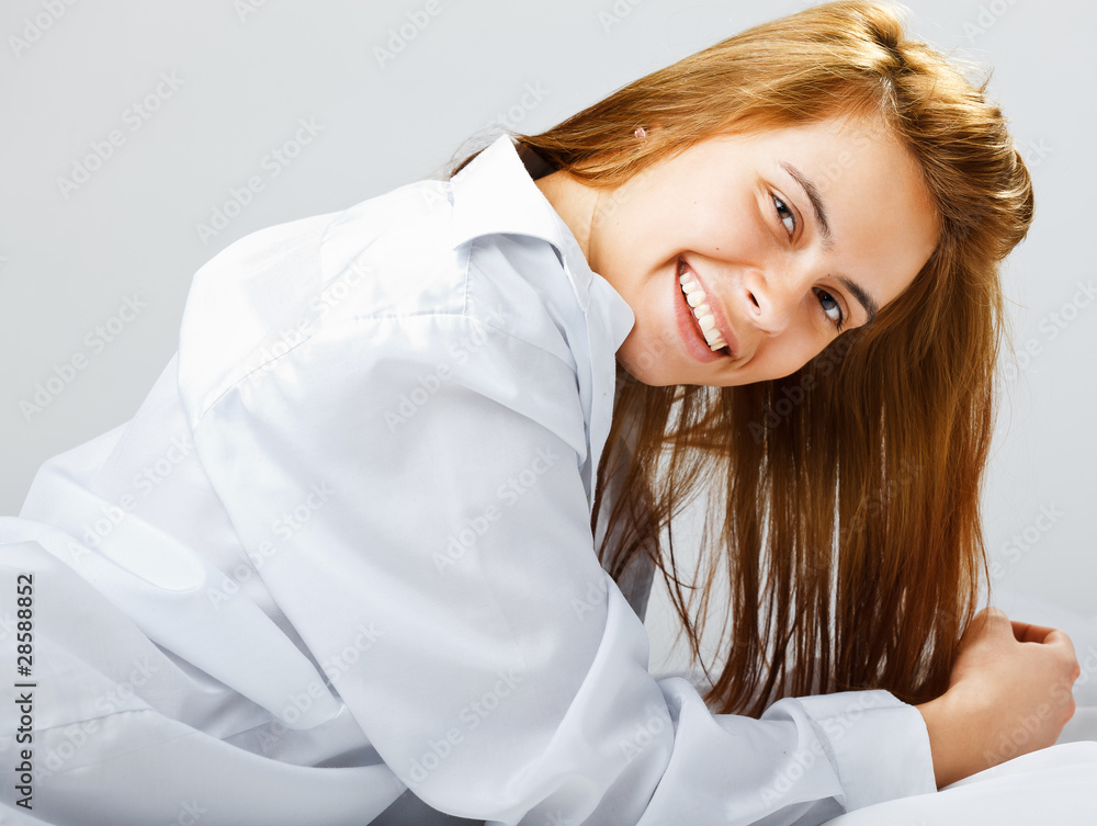 Portrait of a smiling young woman lying on the floor Portrait of a smiling young woman lying on the floor
