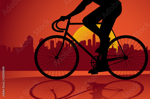 Young man riding a fixed-gear bicycle also called fixie