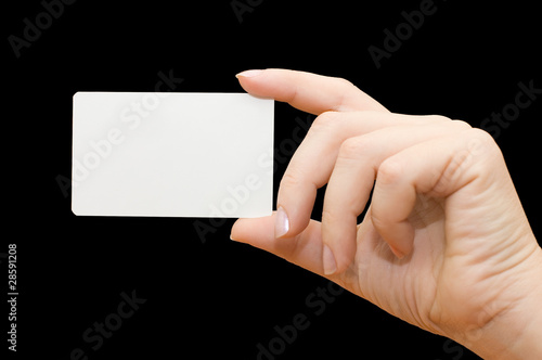 Paper card in woman hand on black background