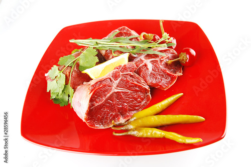 uncooked meat medallion on red