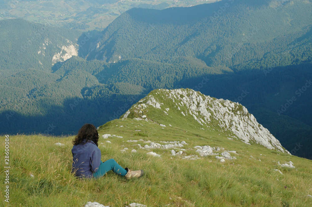 Girl resting in Piatra Craiului mountains, Romania