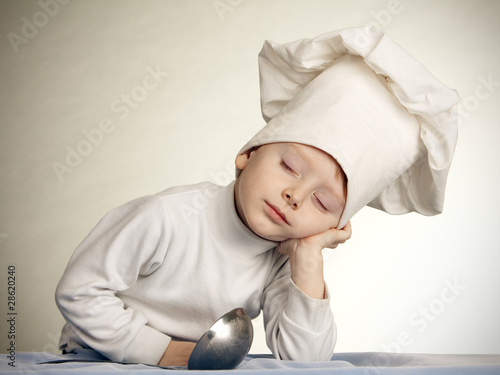 The little boy in a suit of the cook. The cook sleeps