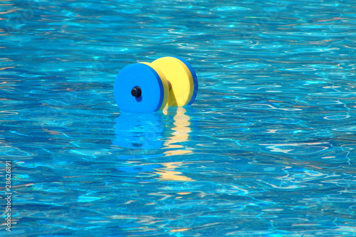 Floating aqua aerobics dumbbell in swimming pool