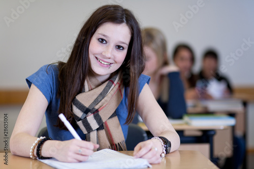 Happy Student has fun while working in classroom photo